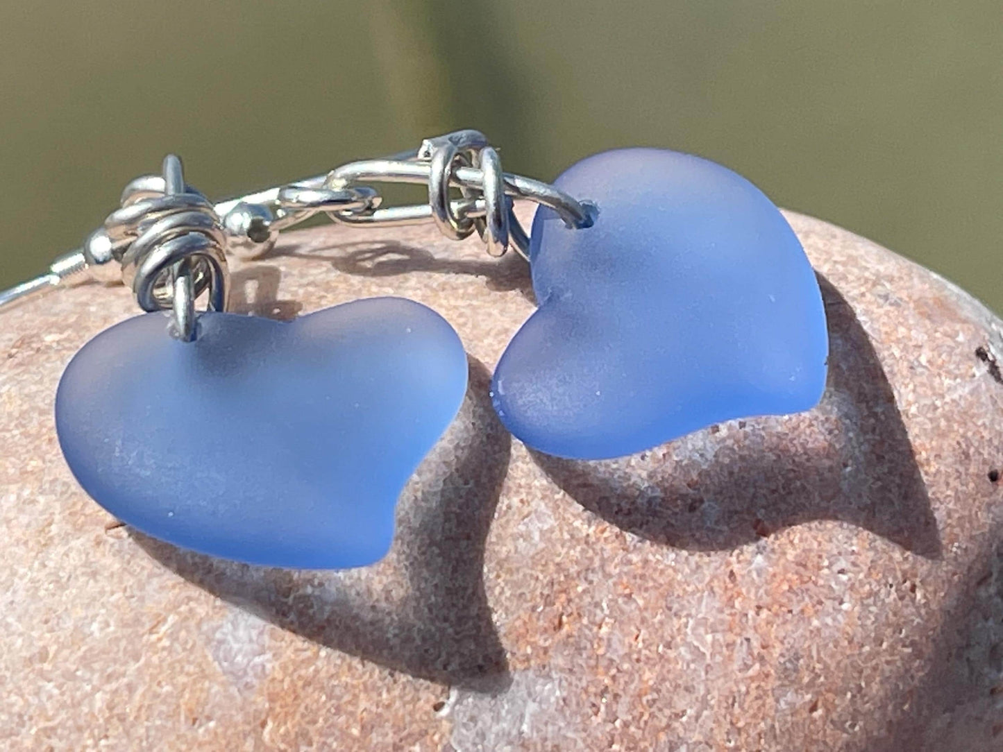 Sea glass heart earrings on recycled sterling silver. Eco conscious jewellery. Ethical jewellery. Blue sea glass hearts. Handmade earrings