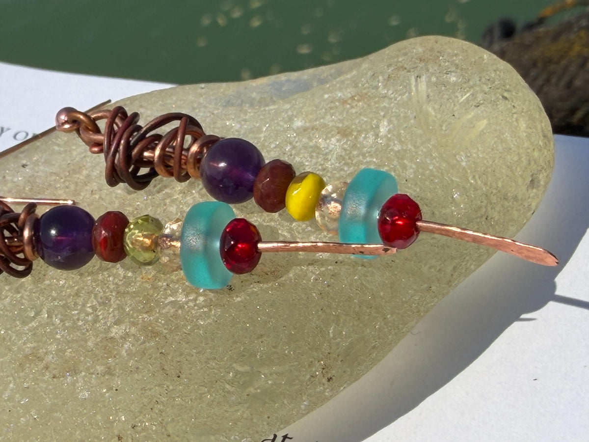 Eco friendly earrings made using recycled copper, sea glass & ethically sourced amethyst. Handmade ethical and unique jewellery. Unusual.