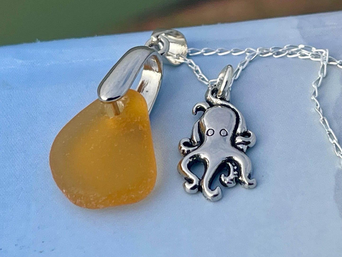 Eco friendly sea glass necklace on a sterling silver chain showcasing a little octopus. Octopus pendant, octopus necklace, ethical jewellery