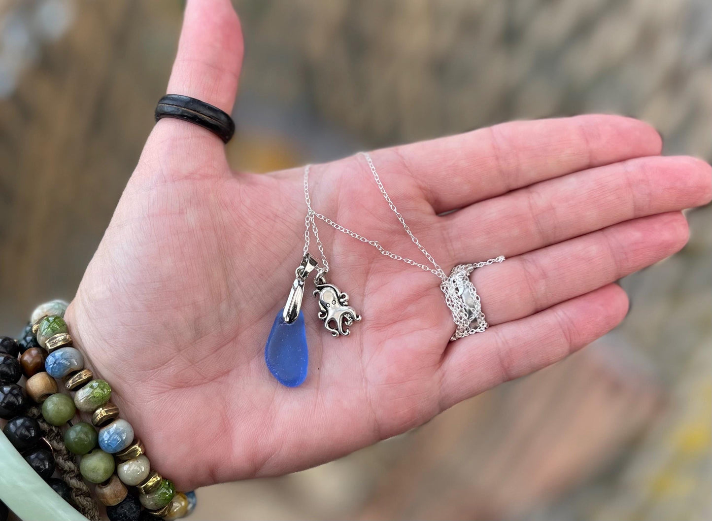 Eco friendly sea glass necklace on a sterling silver chain showcasing a little octopus. Octopus pendant, octopus necklace, ethical jewellery