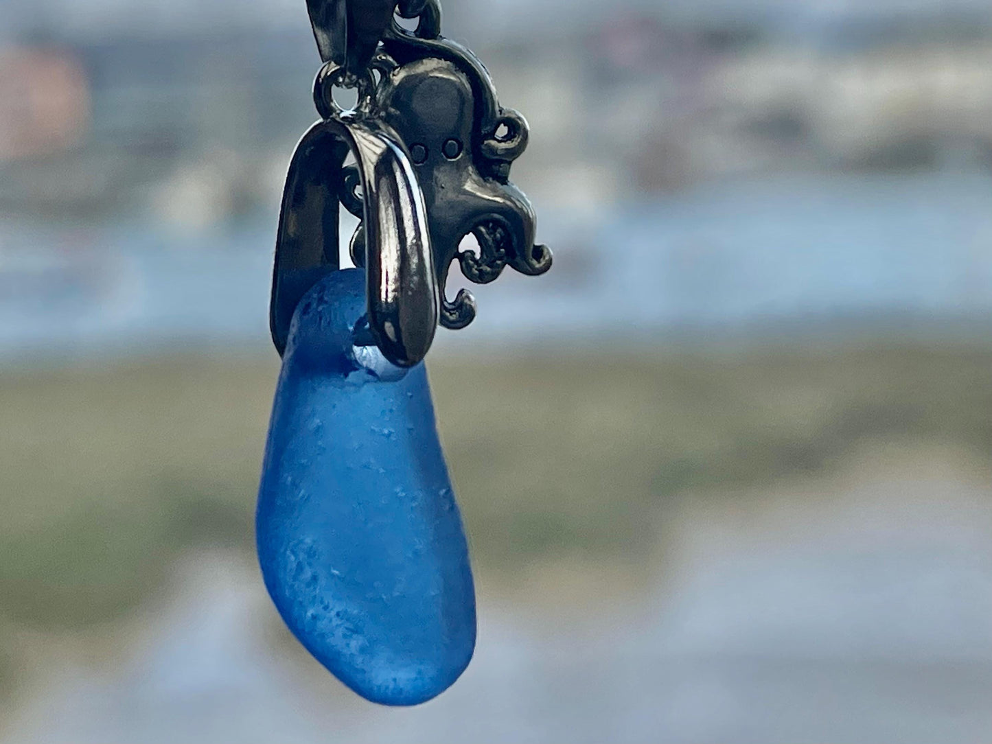 Eco friendly sea glass necklace on a sterling silver chain showcasing a little octopus. Octopus pendant, octopus necklace, ethical jewellery