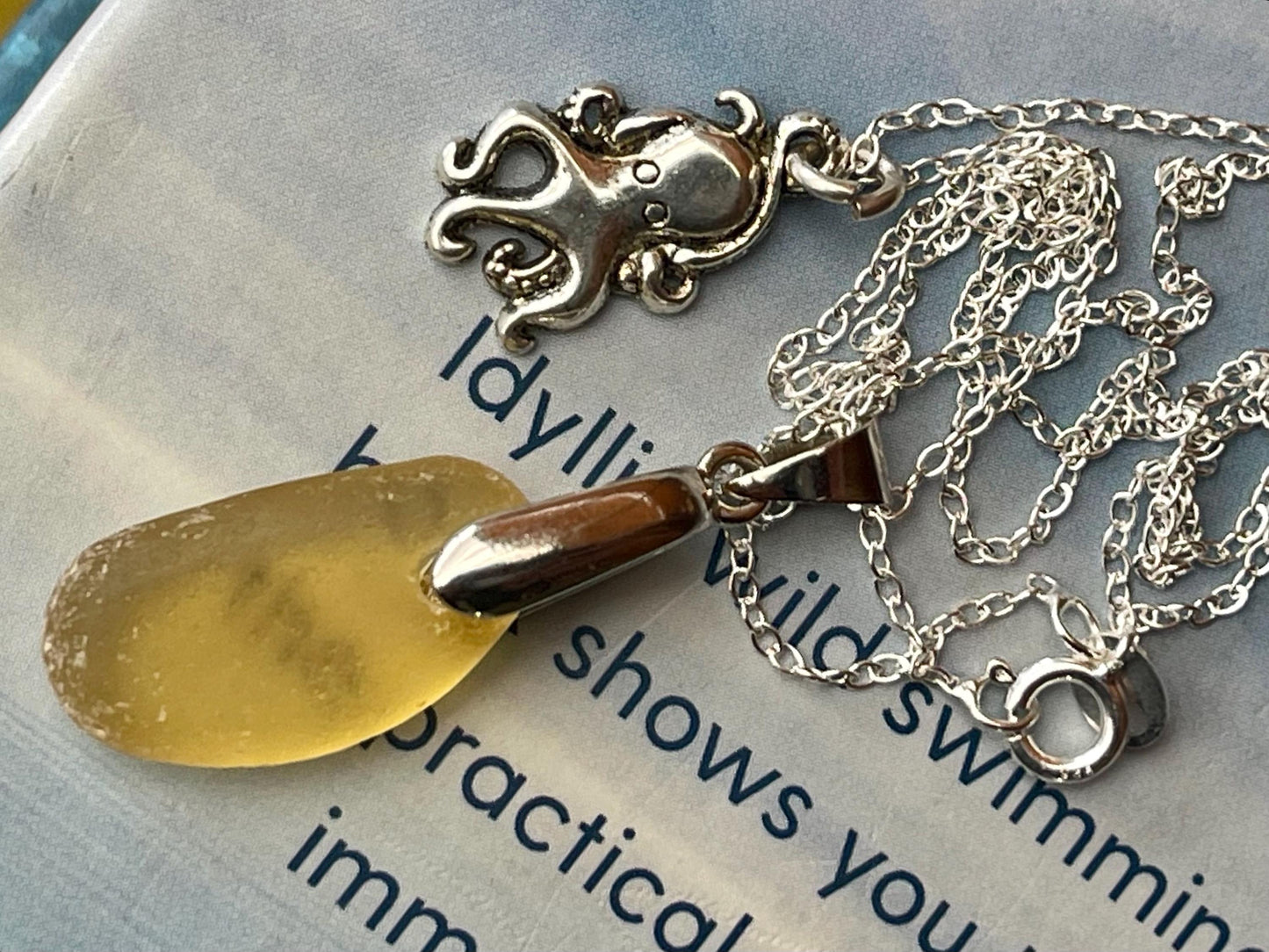 Eco friendly sea glass necklace on a sterling silver chain showcasing a little octopus. Octopus pendant, octopus necklace, ethical jewellery