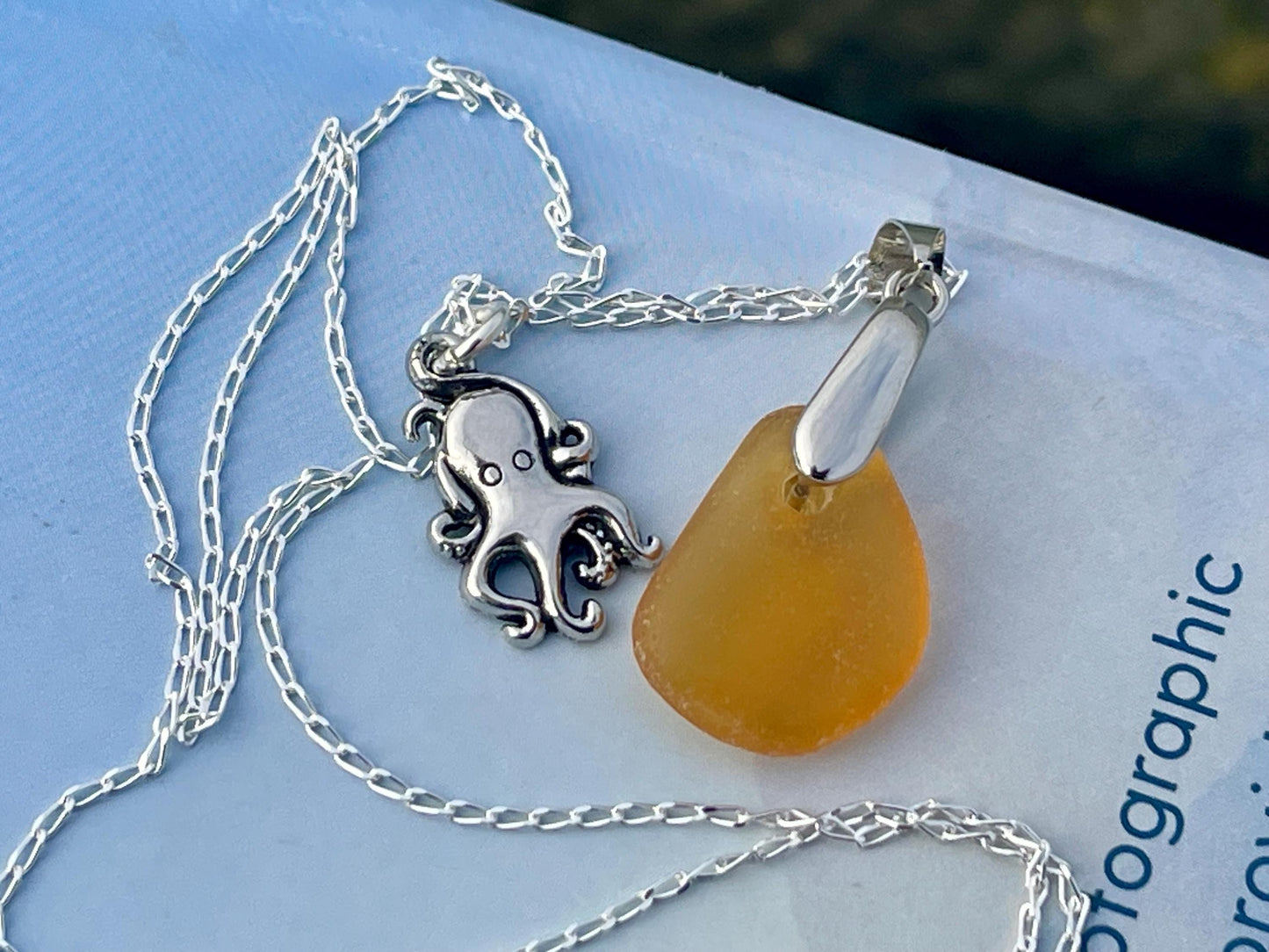 Eco friendly sea glass necklace on a sterling silver chain showcasing a little octopus. Octopus pendant, octopus necklace, ethical jewellery