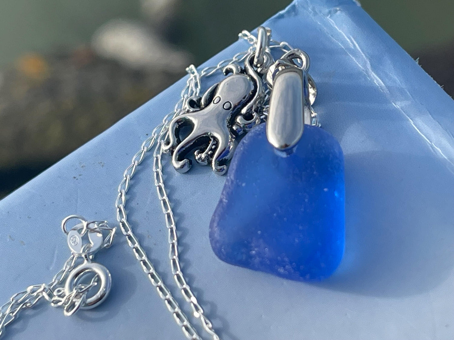 Eco friendly sea glass necklace on a sterling silver chain showcasing a little octopus. Octopus pendant, octopus necklace, ethical jewellery