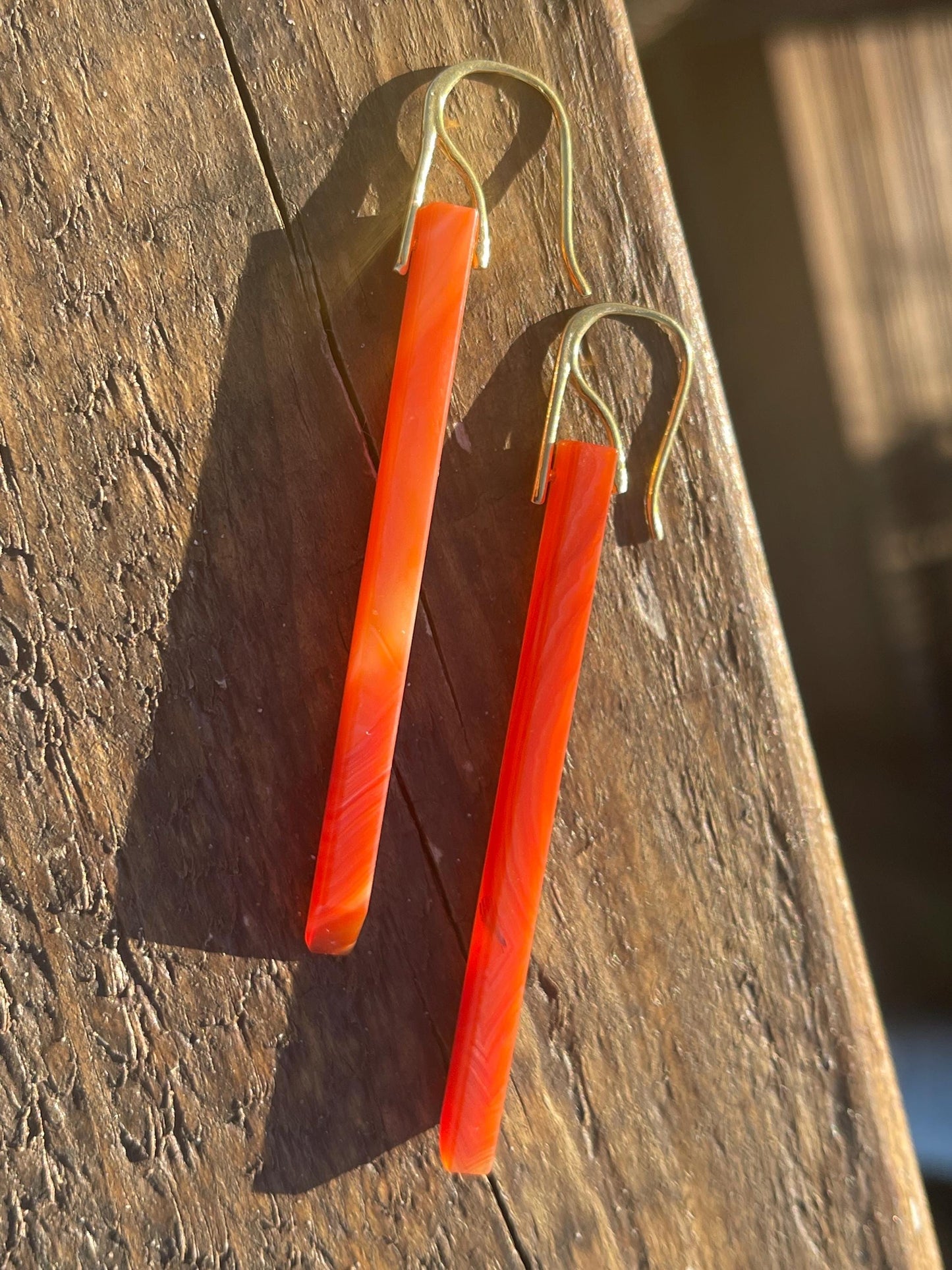 Long red agate gemstone earrings. Orange statement earrings. Long orange earrings. Unique jewellery. Ethical handmade jewellery.