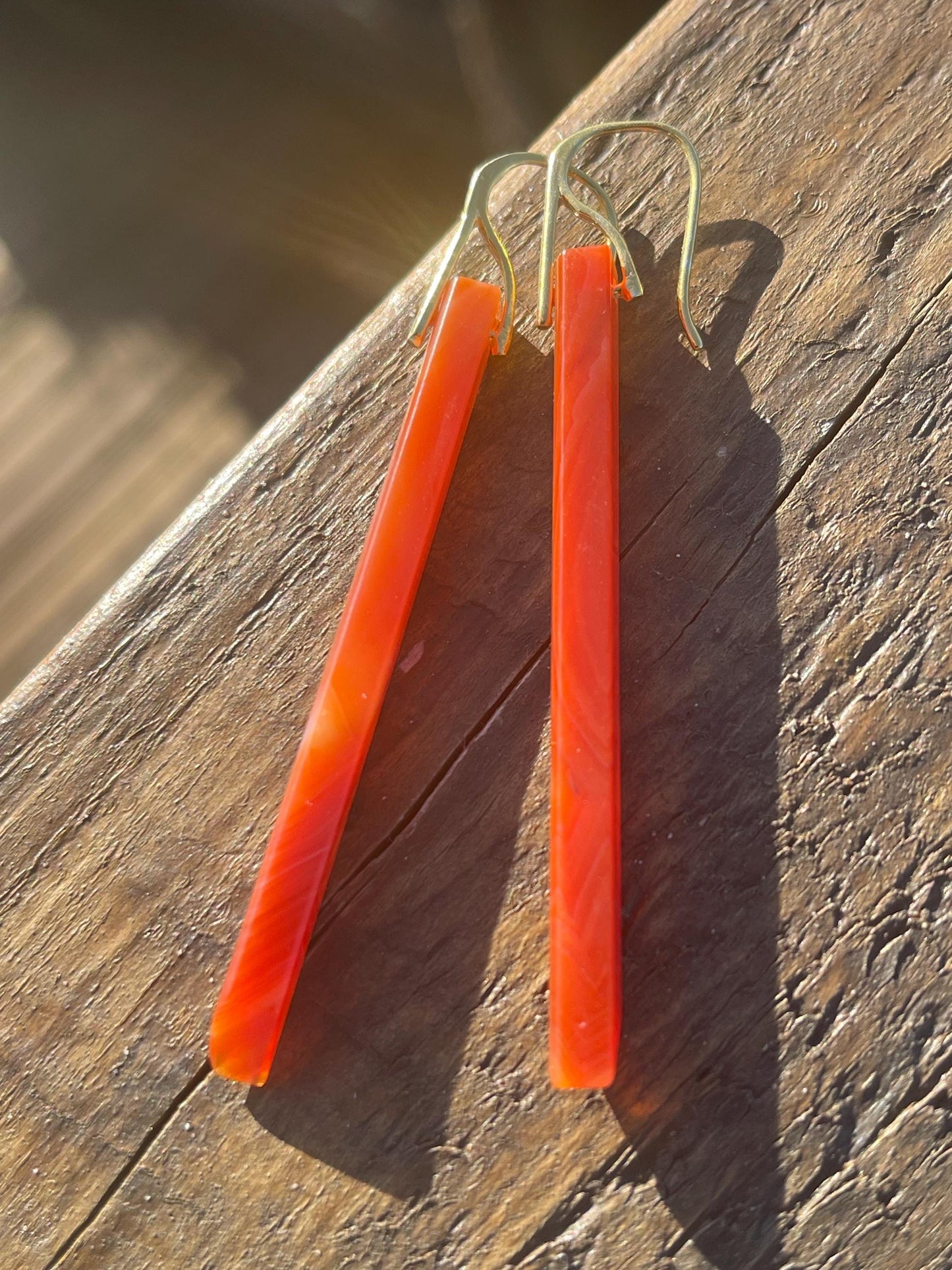 Long red agate gemstone earrings. Orange statement earrings. Long orange earrings. Unique jewellery. Ethical handmade jewellery.