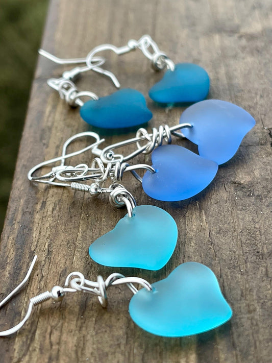 Sea glass heart earrings iron recycled sterling silver. Eco conscious jewellery. Ethical jewellery. Blue sea glass hearts. Handmade earrings