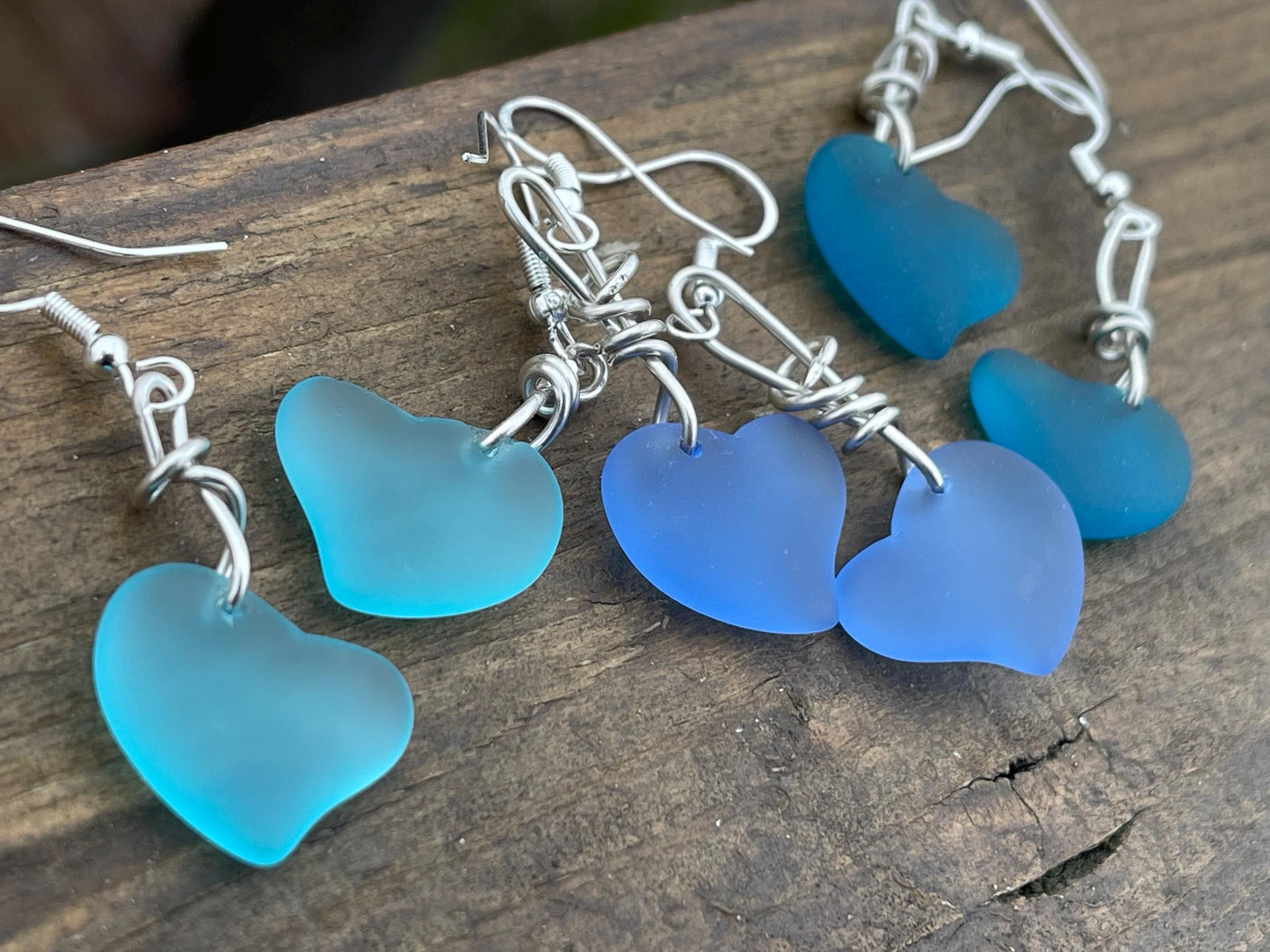 Sea glass heart earrings iron recycled sterling silver. Eco conscious jewellery. Ethical jewellery. Blue sea glass hearts. Handmade earrings