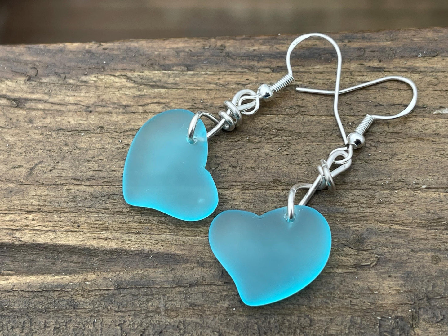 Sea glass heart earrings iron recycled sterling silver. Eco conscious jewellery. Ethical jewellery. Blue sea glass hearts. Handmade earrings