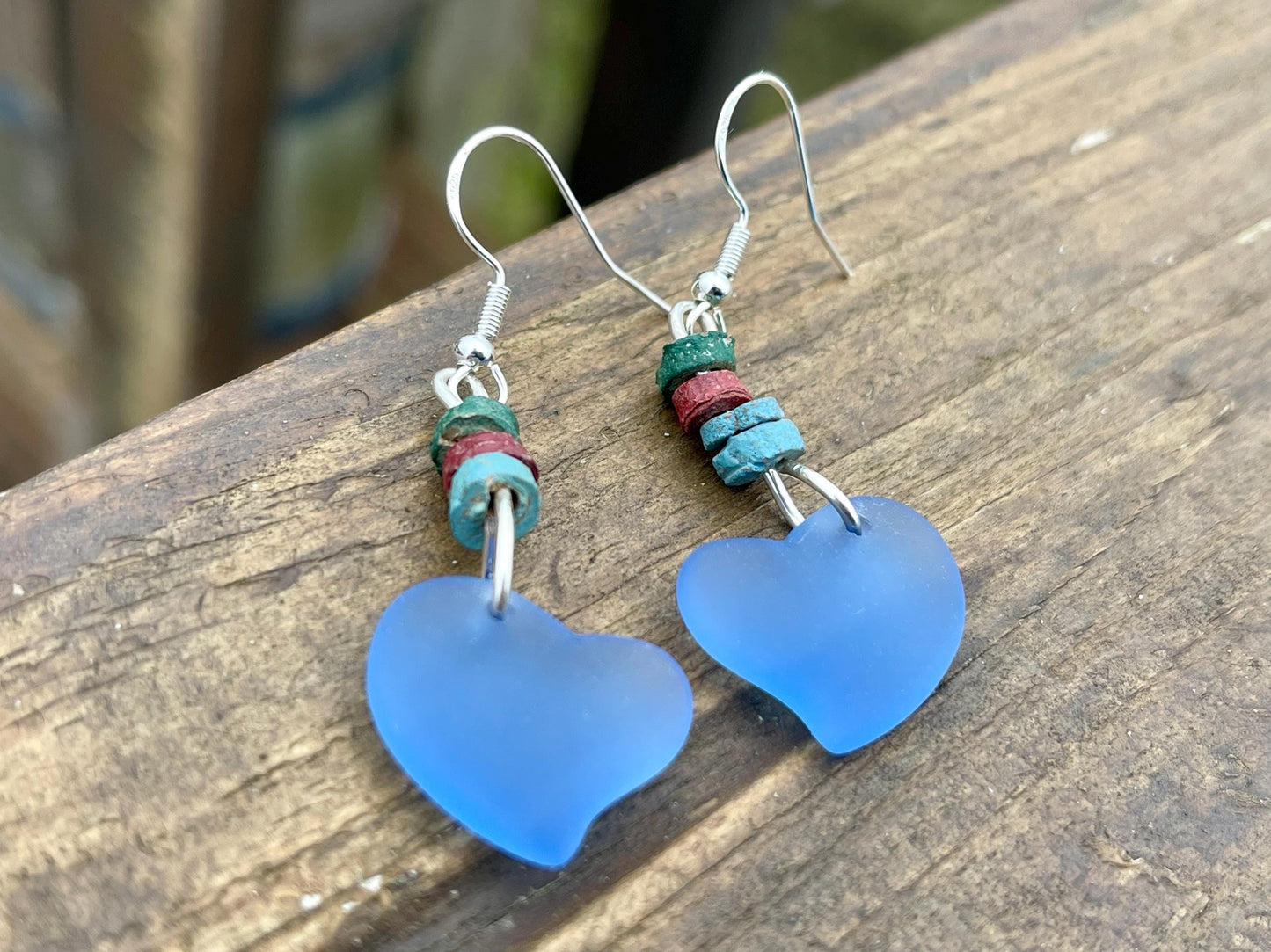 Sea glass heart earrings iron recycled sterling silver. Eco conscious jewellery. Ethical jewellery. Blue sea glass hearts. Handmade earrings