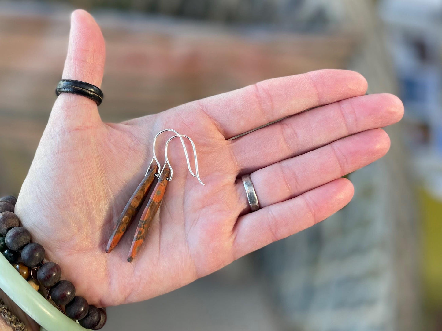 Orange rhyolite gemstone earrings. Long drop dangly earrings. Orange gemstone earrings. Ethical jewellery, orange jewellery. Handmade.