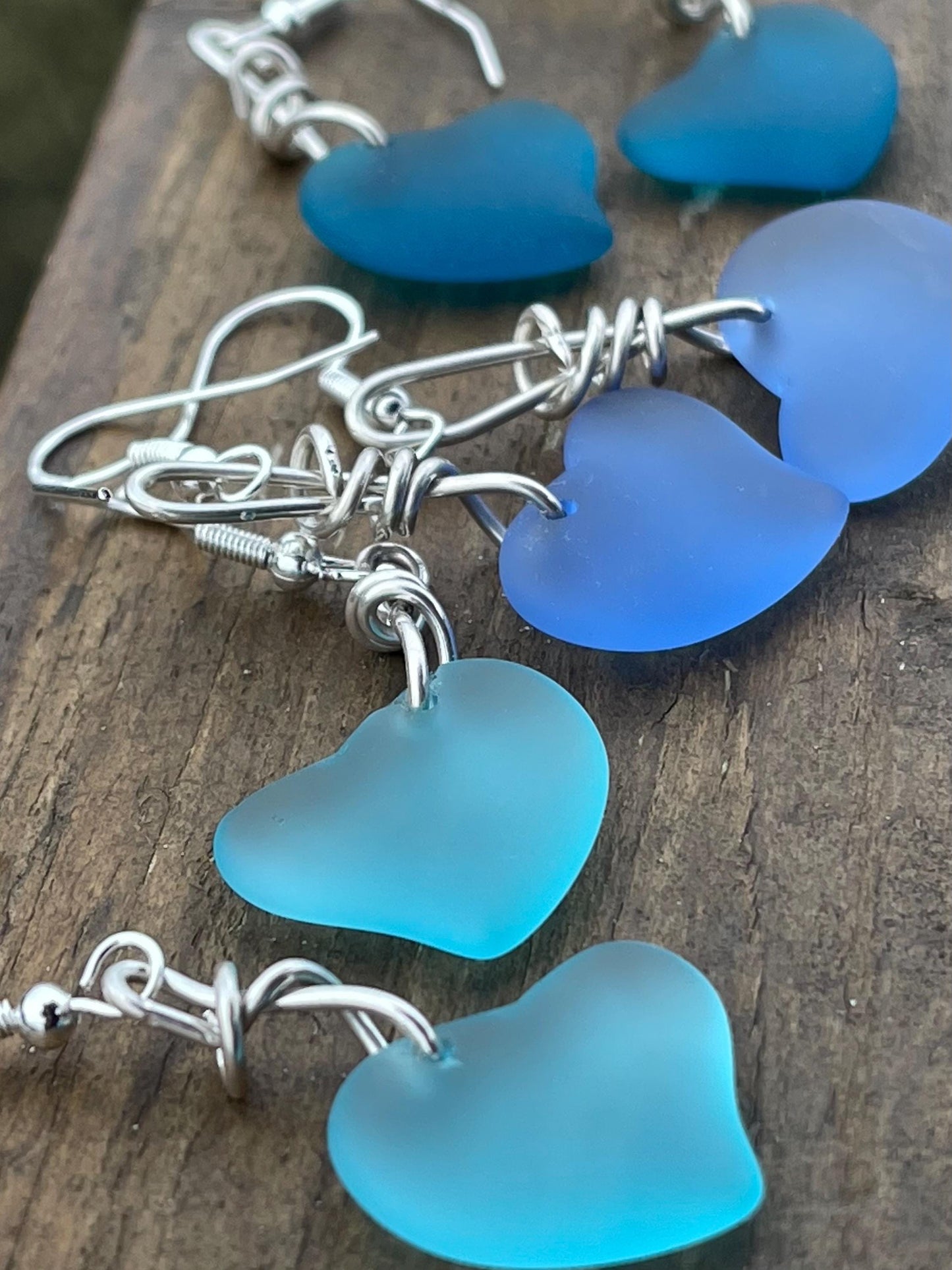 Sea glass heart earrings iron recycled sterling silver. Eco conscious jewellery. Ethical jewellery. Blue sea glass hearts. Handmade earrings