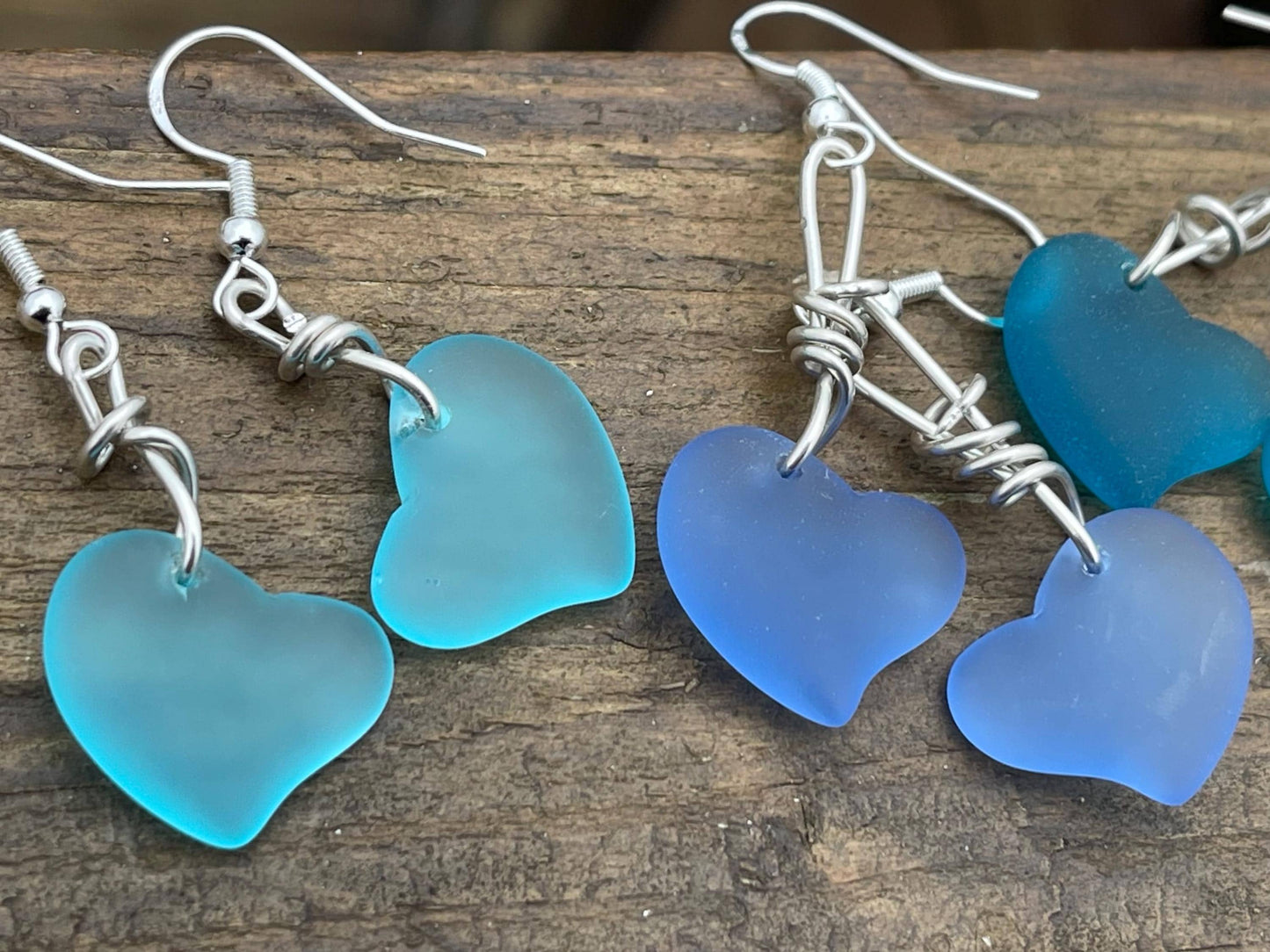 Sea glass heart earrings iron recycled sterling silver. Eco conscious jewellery. Ethical jewellery. Blue sea glass hearts. Handmade earrings