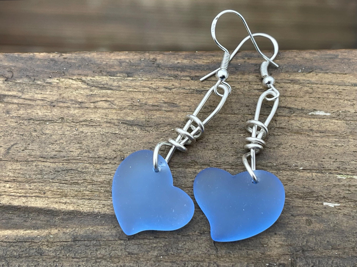 Sea glass heart earrings iron recycled sterling silver. Eco conscious jewellery. Ethical jewellery. Blue sea glass hearts. Handmade earrings