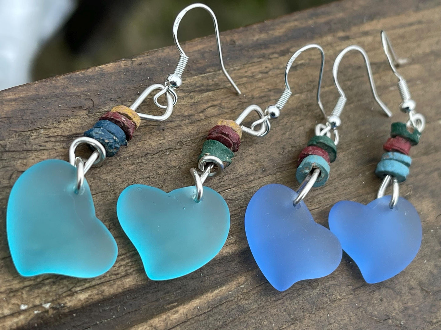 Sea glass heart earrings iron recycled sterling silver. Eco conscious jewellery. Ethical jewellery. Blue sea glass hearts. Handmade earrings