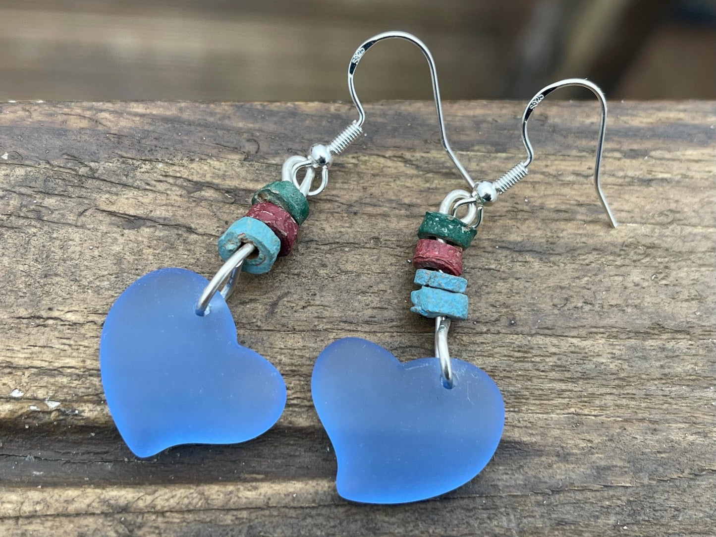 Sea glass heart earrings iron recycled sterling silver. Eco conscious jewellery. Ethical jewellery. Blue sea glass hearts. Handmade earrings