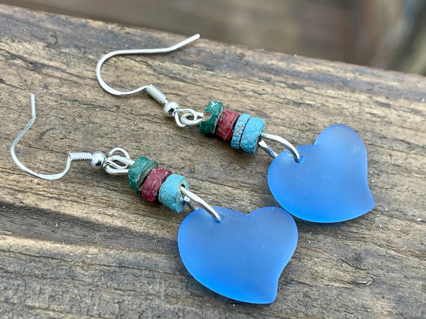 Sea glass heart earrings iron recycled sterling silver. Eco conscious jewellery. Ethical jewellery. Blue sea glass hearts. Handmade earrings