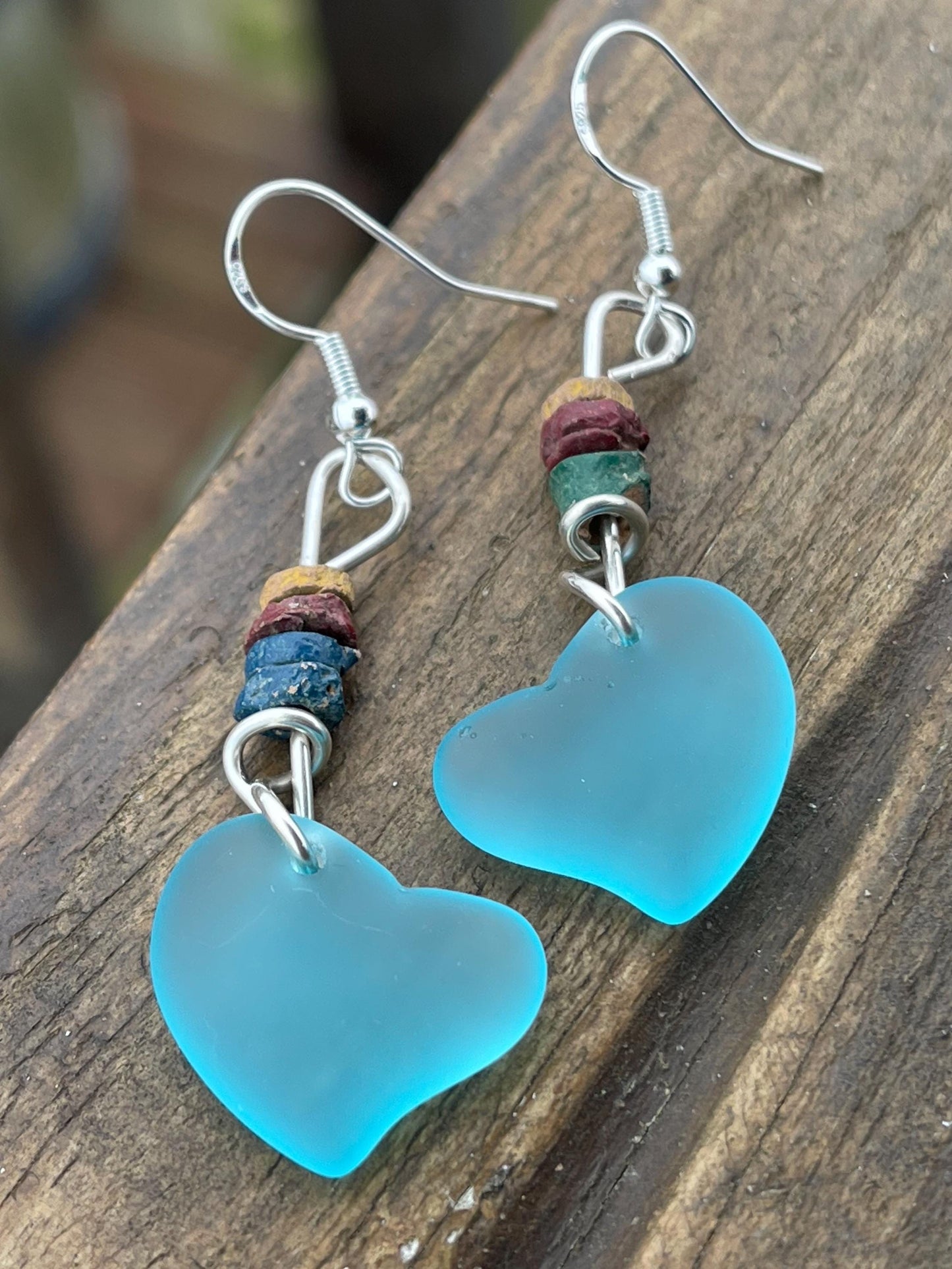 Sea glass heart earrings iron recycled sterling silver. Eco conscious jewellery. Ethical jewellery. Blue sea glass hearts. Handmade earrings