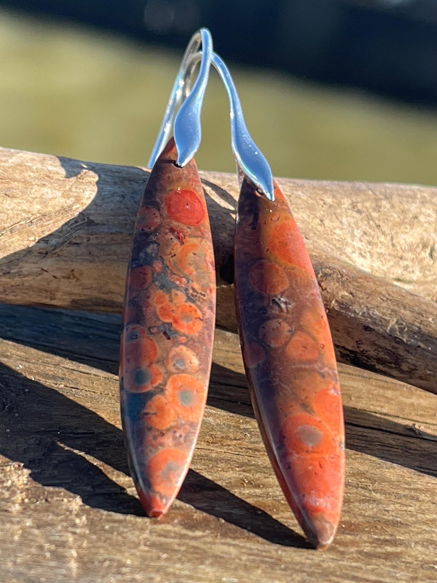 Orange rhyolite gemstone earrings. Long drop dangly earrings. Orange gemstone earrings. Ethical jewellery, orange jewellery. Handmade.