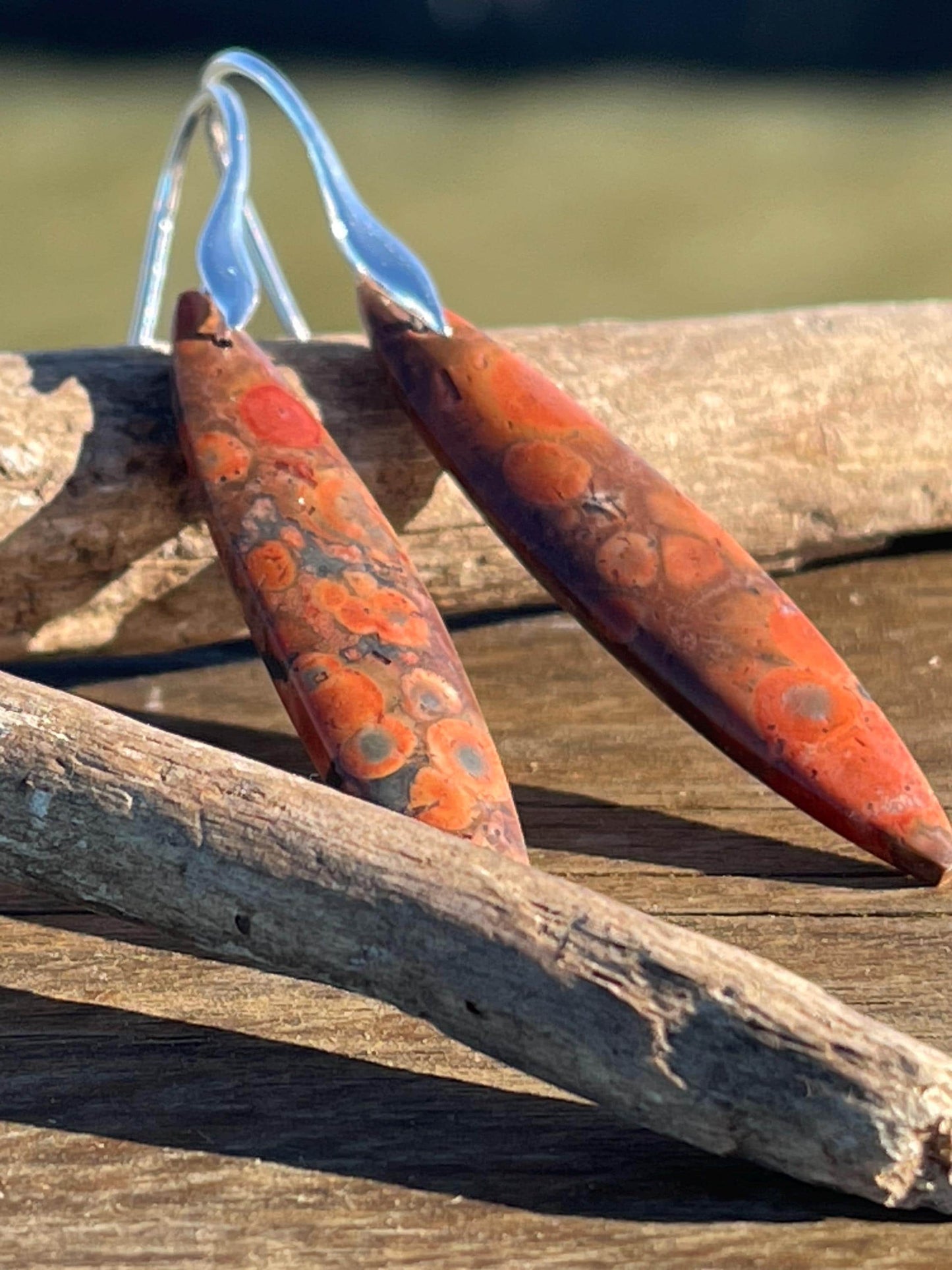 Orange rhyolite gemstone earrings. Long drop dangly earrings. Orange gemstone earrings. Ethical jewellery, orange jewellery. Handmade.