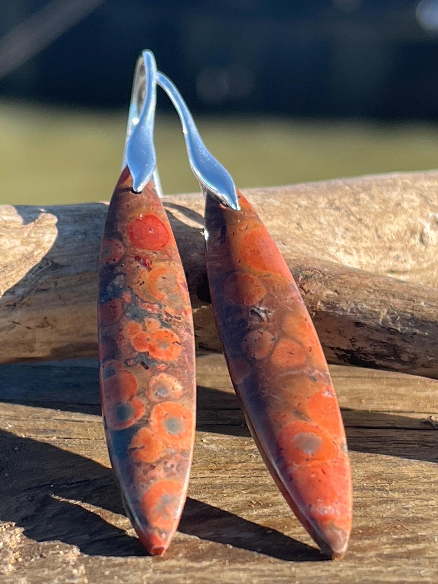 Orange rhyolite gemstone earrings. Long drop dangly earrings. Orange gemstone earrings. Ethical jewellery, orange jewellery. Handmade.