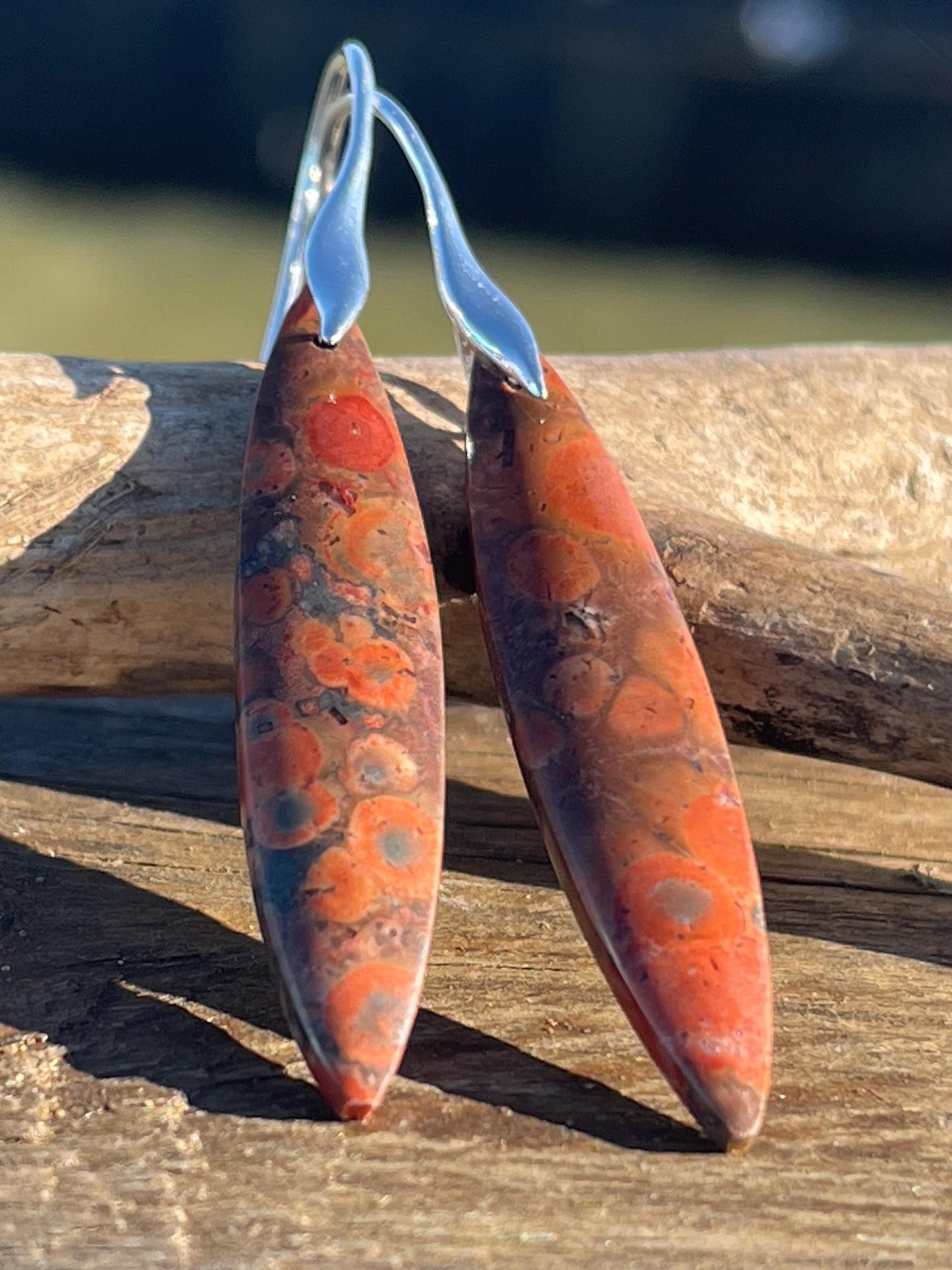 Orange rhyolite gemstone earrings. Long drop dangly earrings. Orange gemstone earrings. Ethical jewellery, orange jewellery. Handmade.