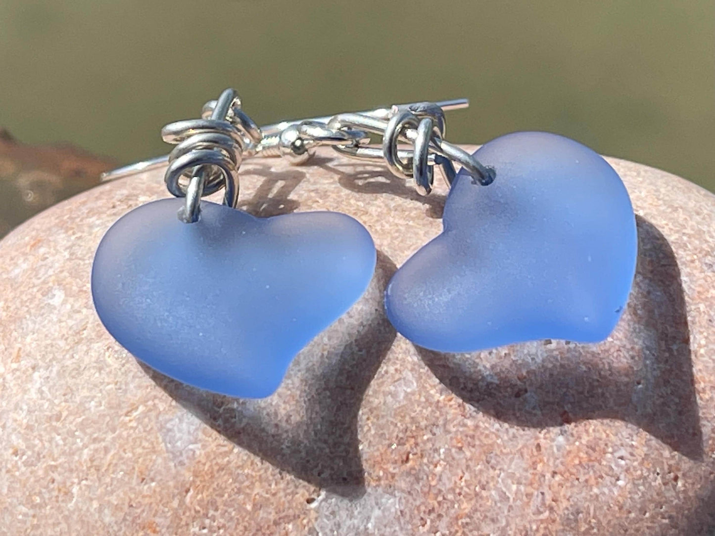 Sea glass heart earrings on recycled sterling silver. Eco conscious jewellery. Ethical jewellery. Blue sea glass hearts. Handmade earrings