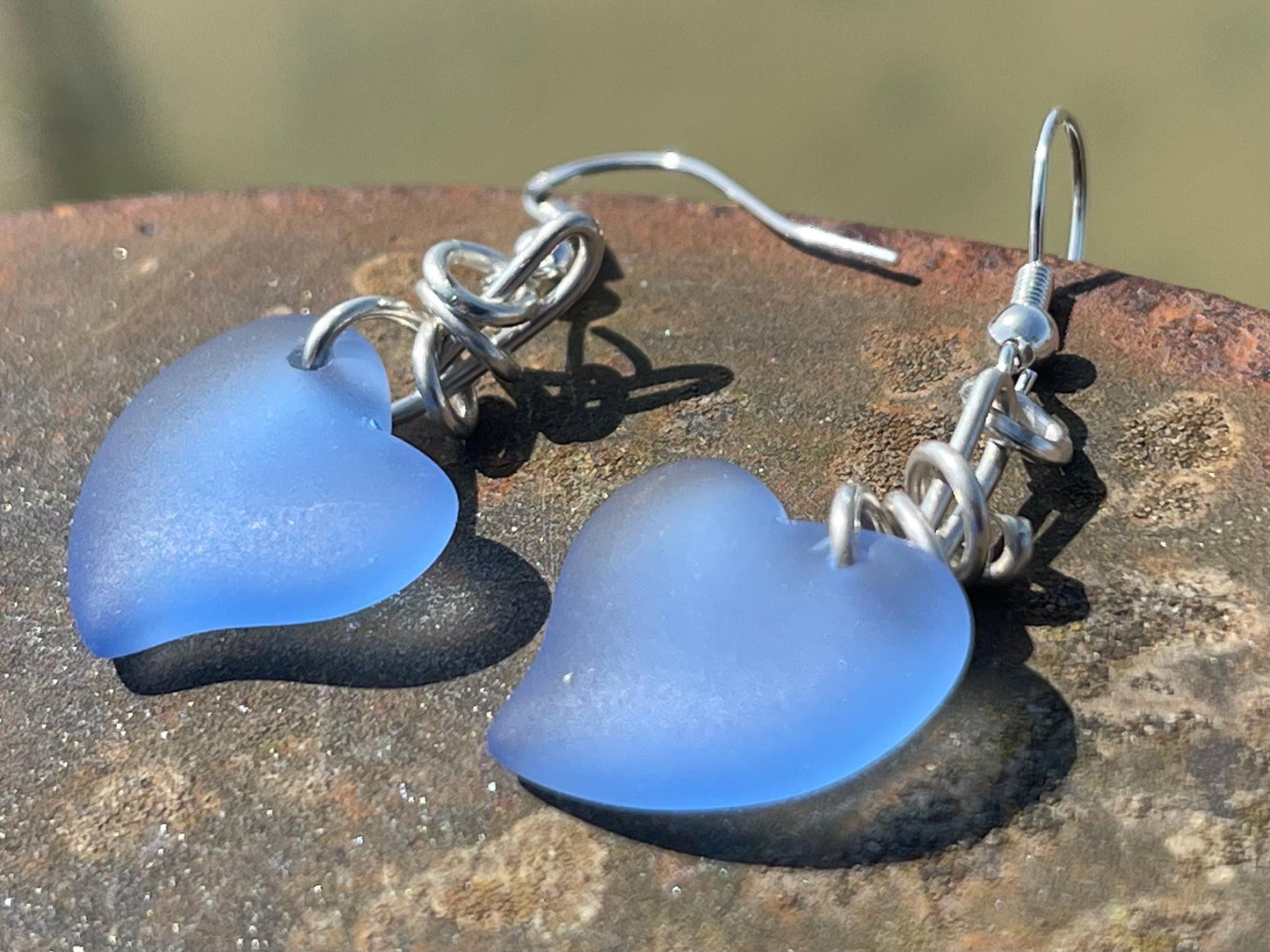 Sea glass heart earrings on recycled sterling silver. Eco conscious jewellery. Ethical jewellery. Blue sea glass hearts. Handmade earrings