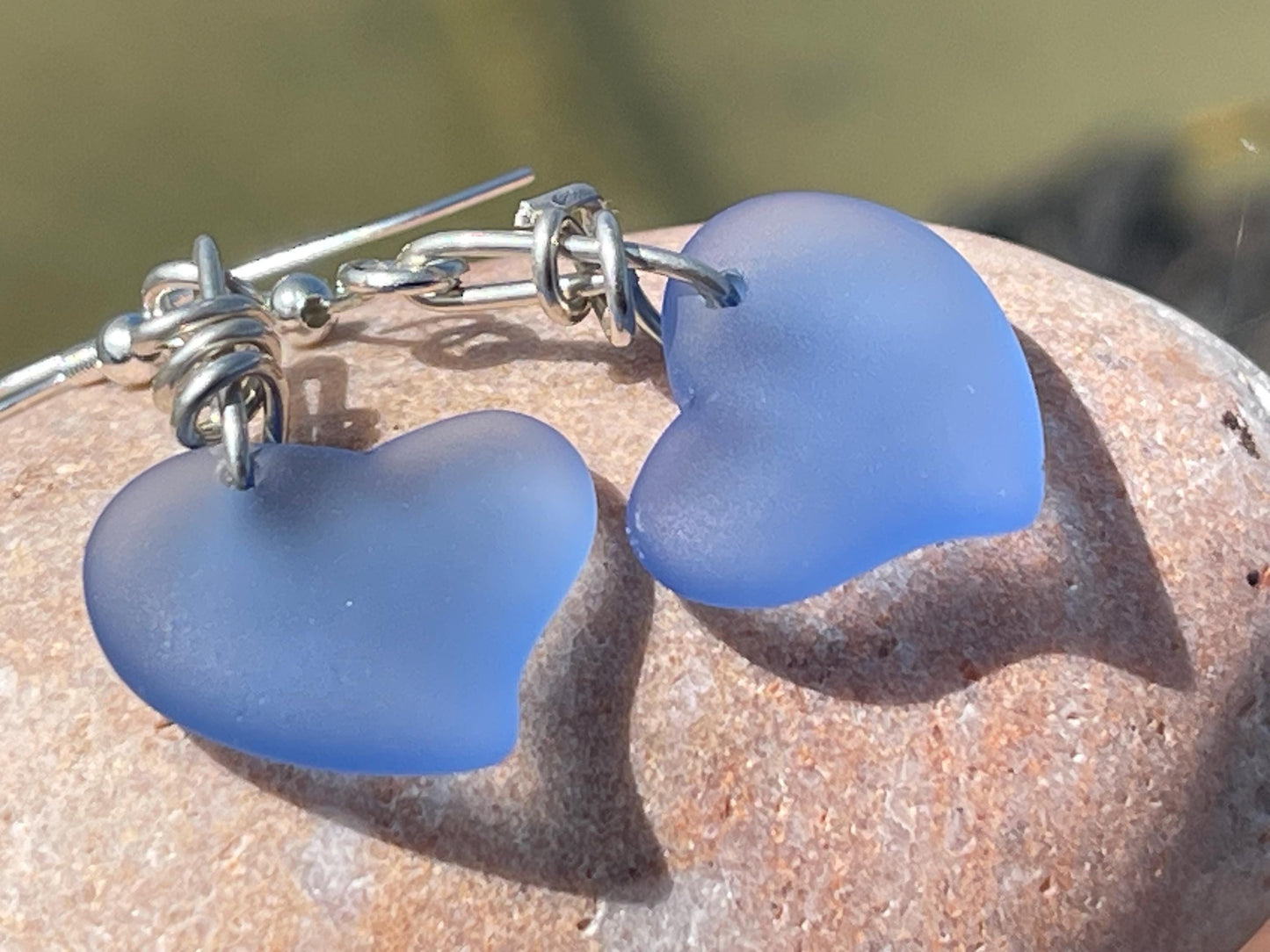 Sea glass heart earrings on recycled sterling silver. Eco conscious jewellery. Ethical jewellery. Blue sea glass hearts. Handmade earrings