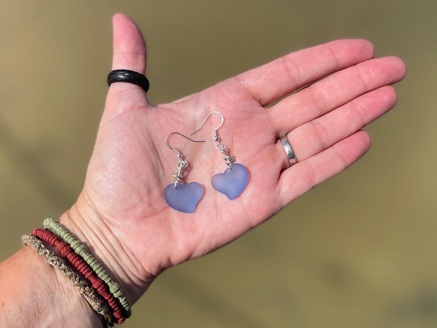 Sea glass heart earrings on recycled sterling silver. Eco conscious jewellery. Ethical jewellery. Blue sea glass hearts. Handmade earrings