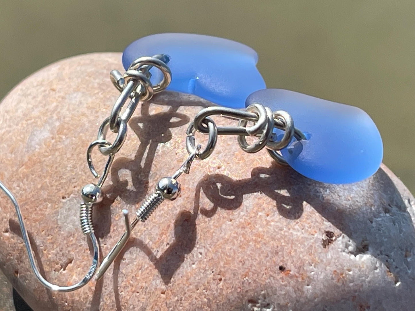 Sea glass heart earrings on recycled sterling silver. Eco conscious jewellery. Ethical jewellery. Blue sea glass hearts. Handmade earrings
