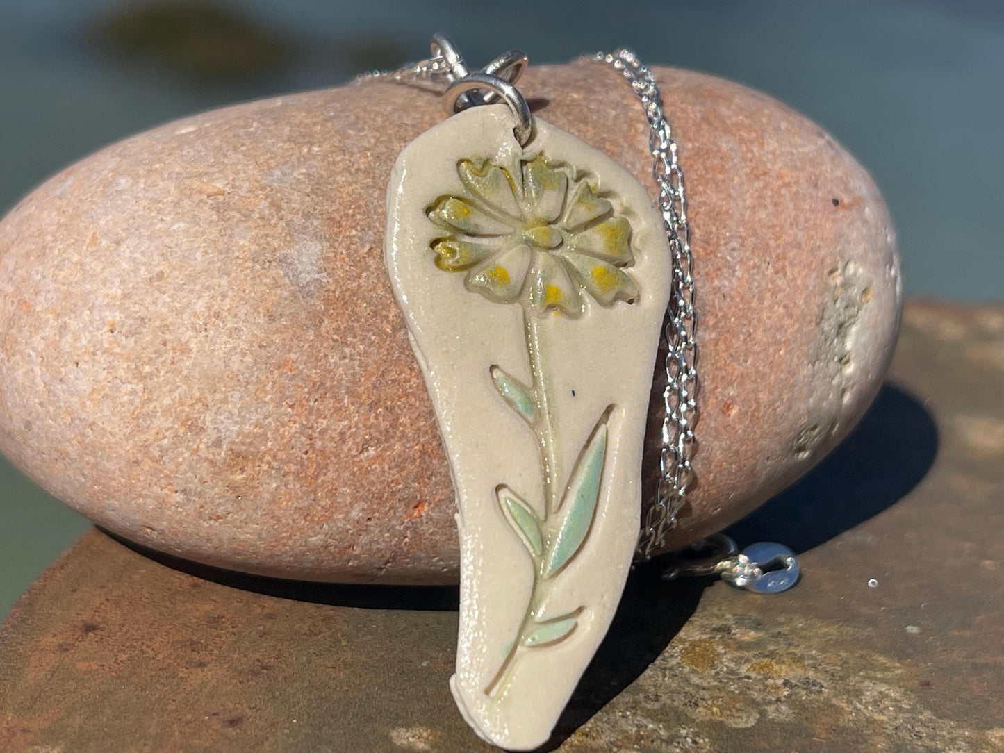 Handmade daisy necklace. Eco friendly jewellery. Ethical pendants made with waste clay and recycled sterling silver. Ethical jewellery.