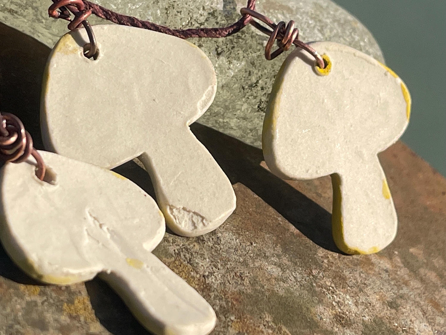 Handmade mushroom necklaces. Eco friendly jewellery. Ethical pendants made with waste clay and burnt recycled copper. Ethical jewellery.