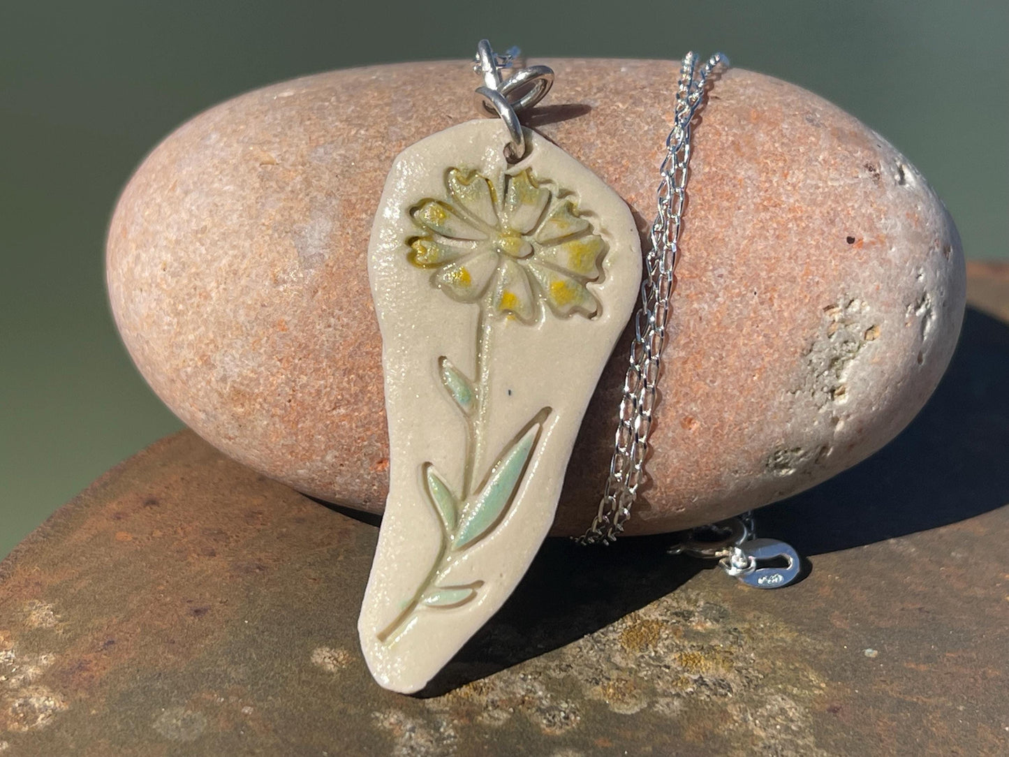 Handmade daisy necklace. Eco friendly jewellery. Ethical pendants made with waste clay and recycled sterling silver. Ethical jewellery.