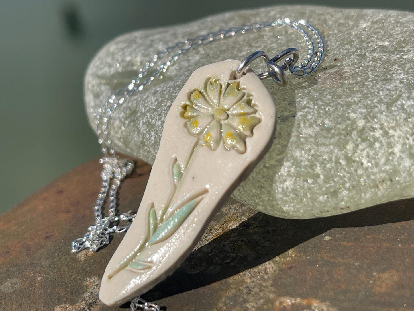 Handmade daisy necklace. Eco friendly jewellery. Ethical pendants made with waste clay and recycled sterling silver. Ethical jewellery.