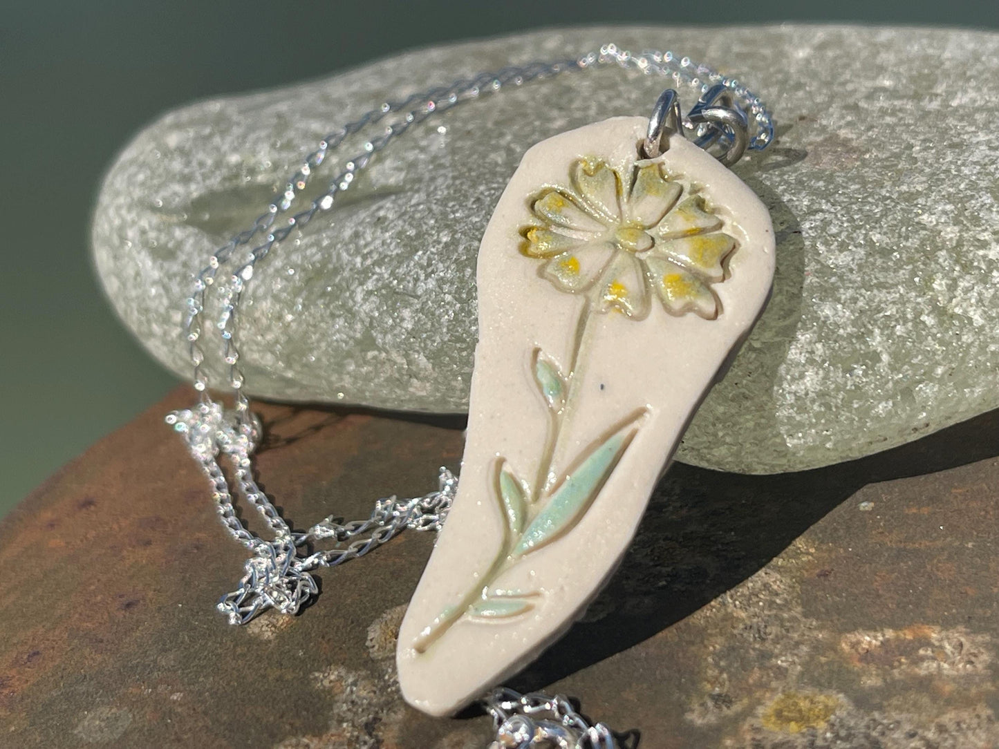 Handmade daisy necklace. Eco friendly jewellery. Ethical pendants made with waste clay and recycled sterling silver. Ethical jewellery.