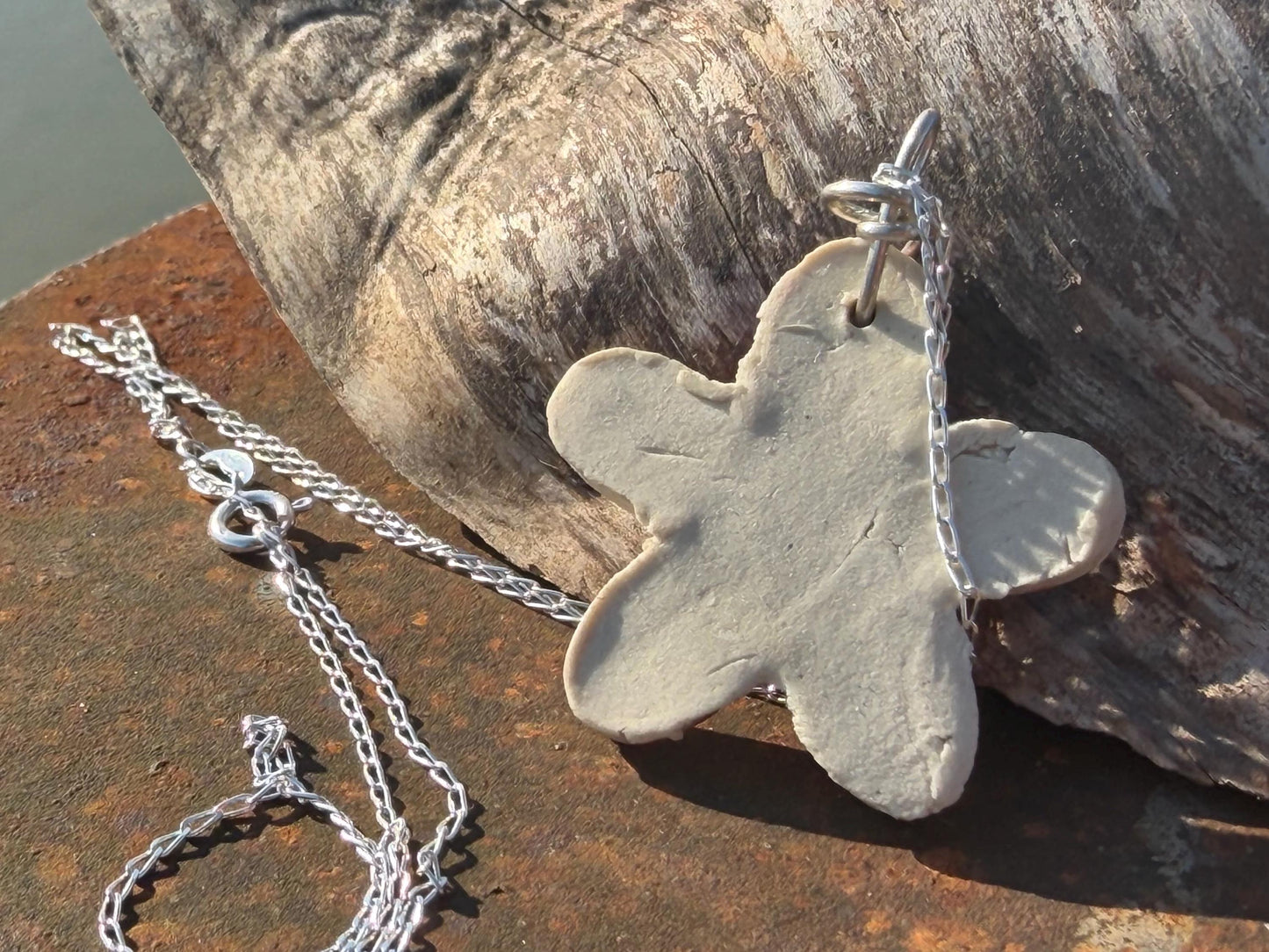 Handmade ceramic flower necklace on a recycled sterling silver chain. Eco friendly jewellery, ethical jewellery, eco necklaces.