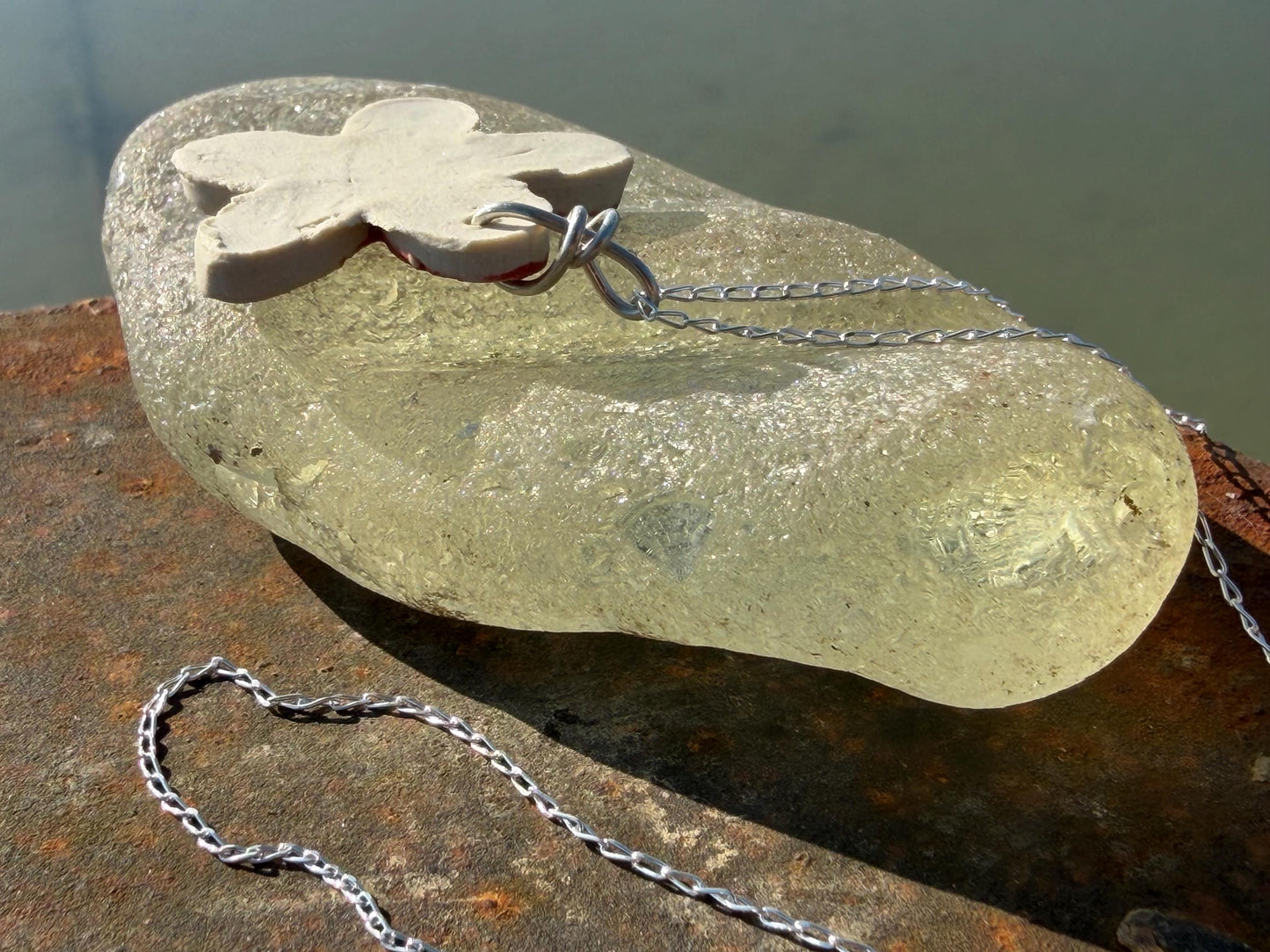 Handmade ceramic flower necklace on a recycled sterling silver chain. Eco friendly jewellery, ethical jewellery, eco necklaces.