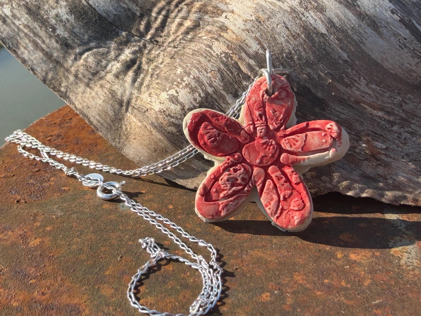 Handmade ceramic flower necklace on a recycled sterling silver chain. Eco friendly jewellery, ethical jewellery, eco necklaces.