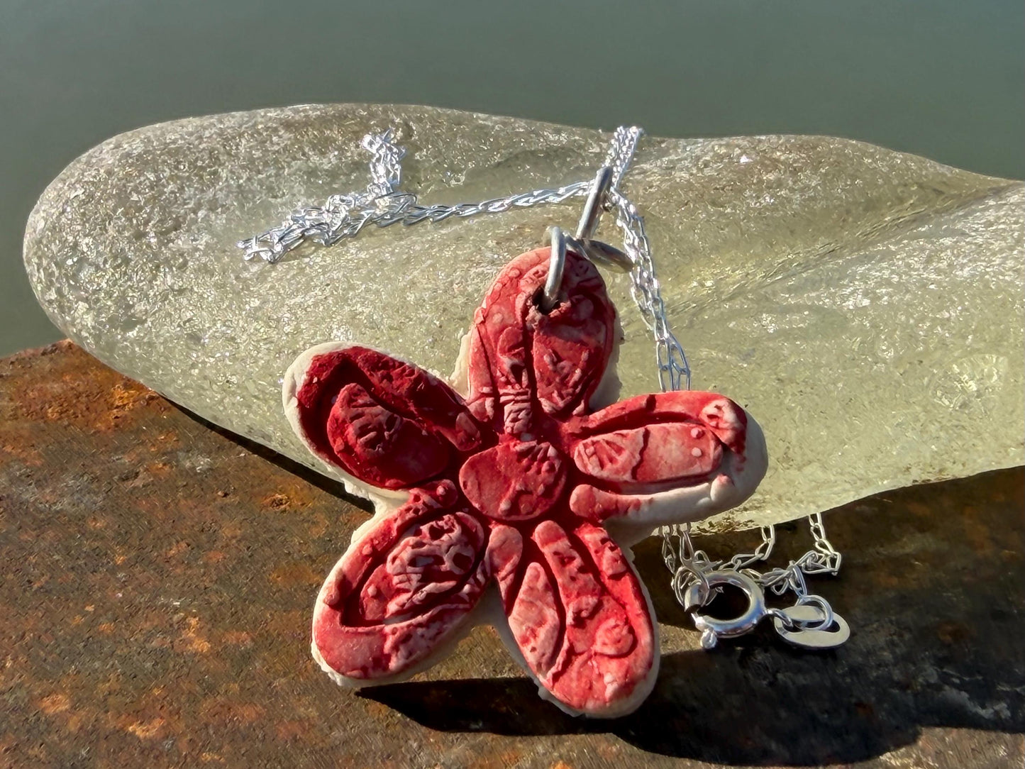 Handmade ceramic flower necklace on a recycled sterling silver chain. Eco friendly jewellery, ethical jewellery, eco necklaces.