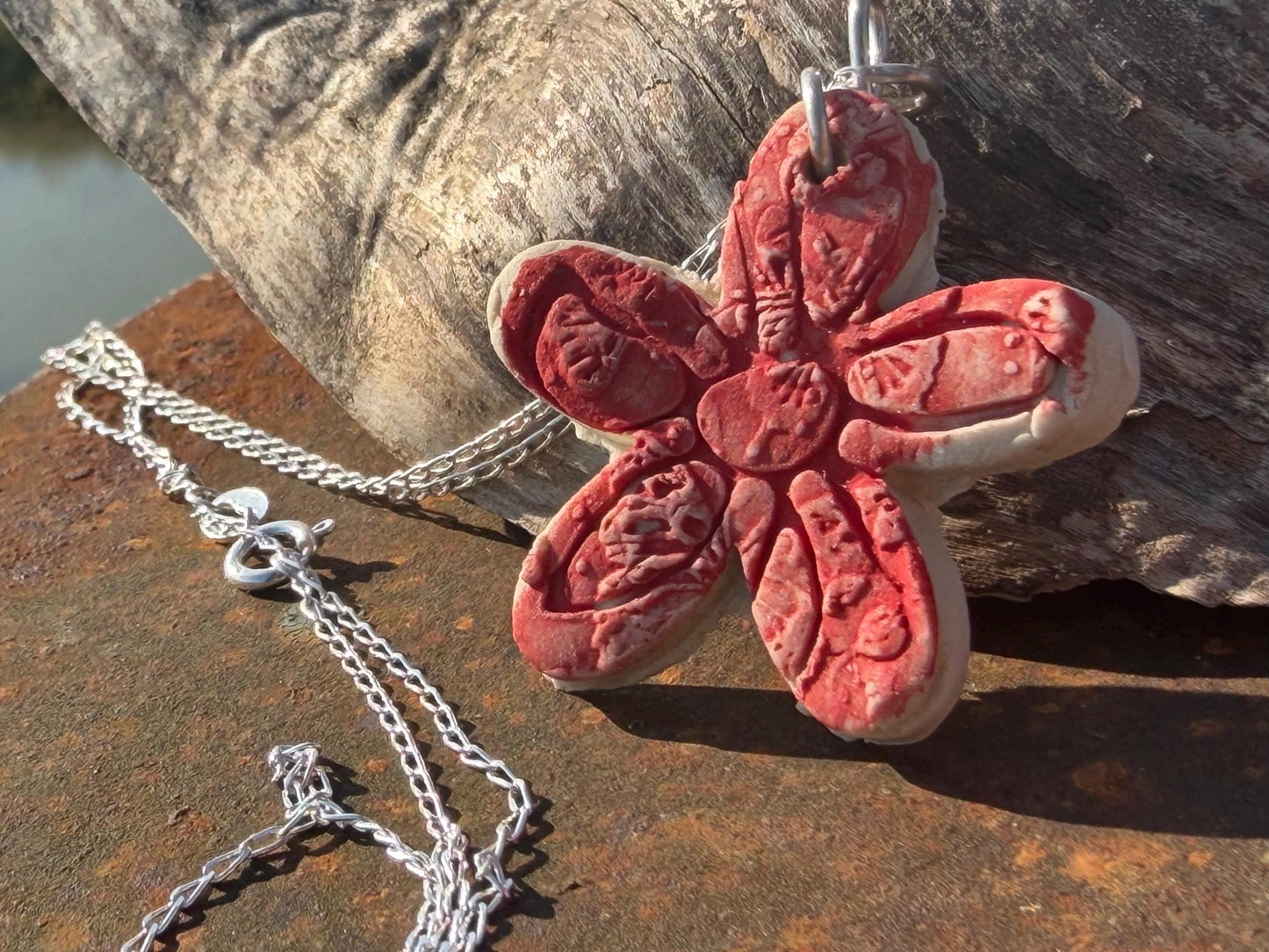 Handmade ceramic flower necklace on a recycled sterling silver chain. Eco friendly jewellery, ethical jewellery, eco necklaces.