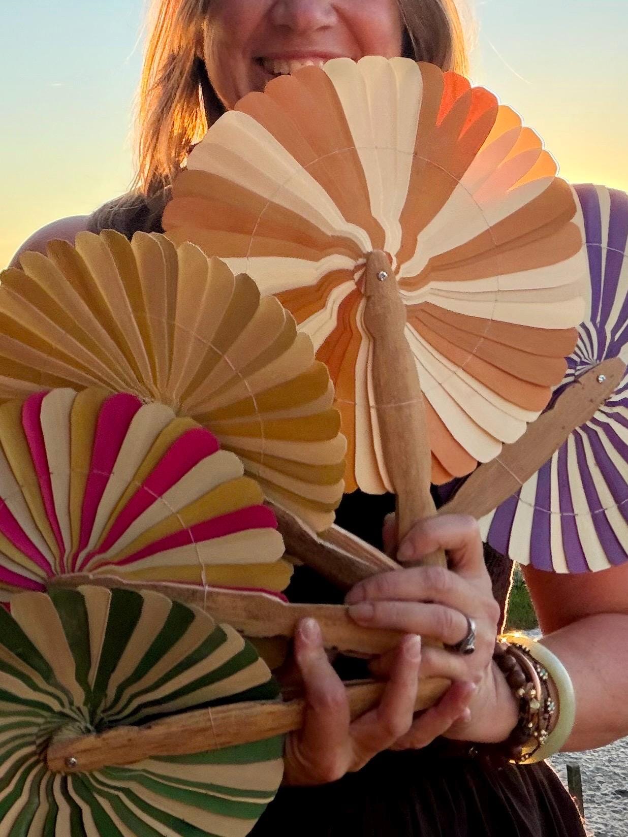Absolutely beautiful eco friendly handheld bamboo fans. A wide range of colours. Large handmade fans. Eco gifts. Red, orange, green, purple.
