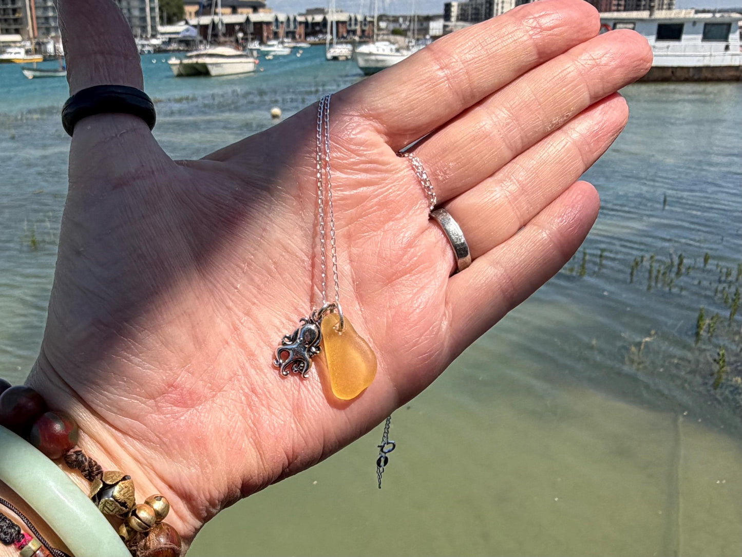 Eco friendly sea glass necklace on a sterling silver chain showcasing a little octopus. Octopus pendant, octopus necklace, eco jewellery