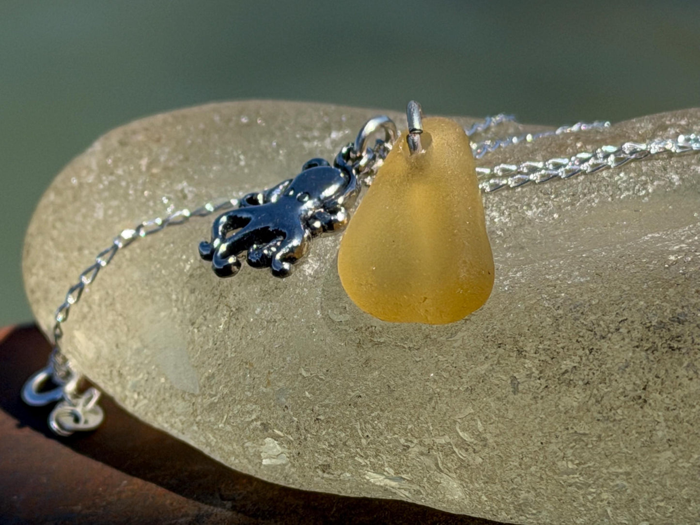 Eco friendly sea glass necklace on a sterling silver chain showcasing a little octopus. Octopus pendant, octopus necklace, eco jewellery