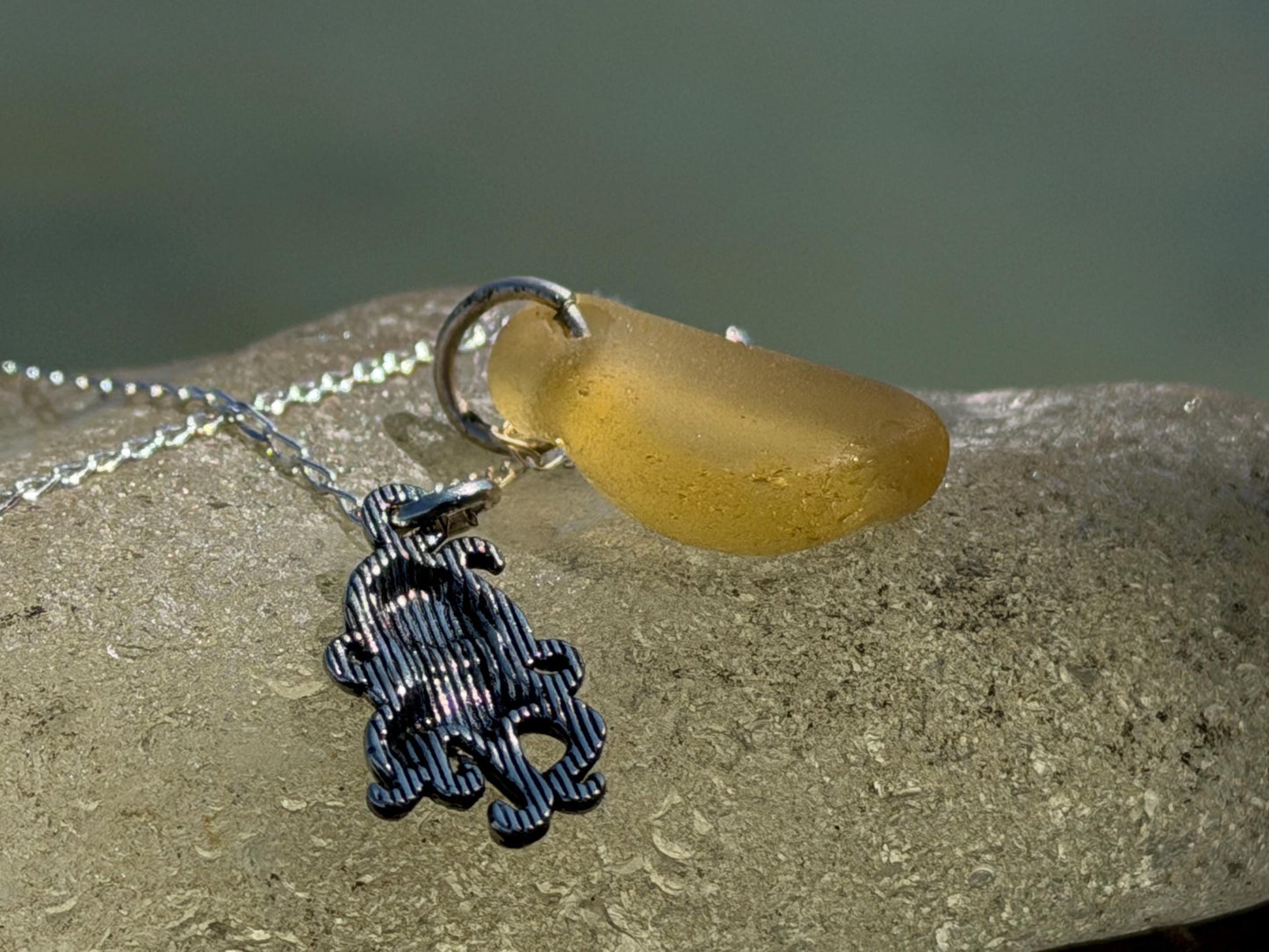Eco friendly sea glass necklace on a sterling silver chain showcasing a little octopus. Octopus pendant, octopus necklace, eco jewellery