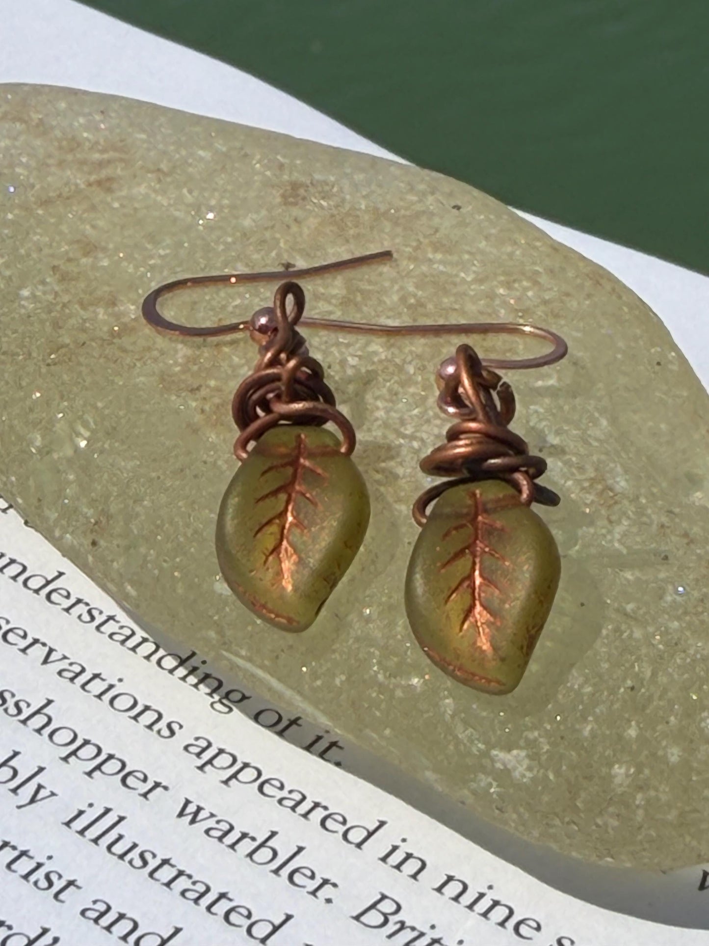 Upcycled glass leaves wrapped in recycled copper. Held on rose gold ear hooks. Eco friendly jewellery. Unique earrings. Leaf earrings.