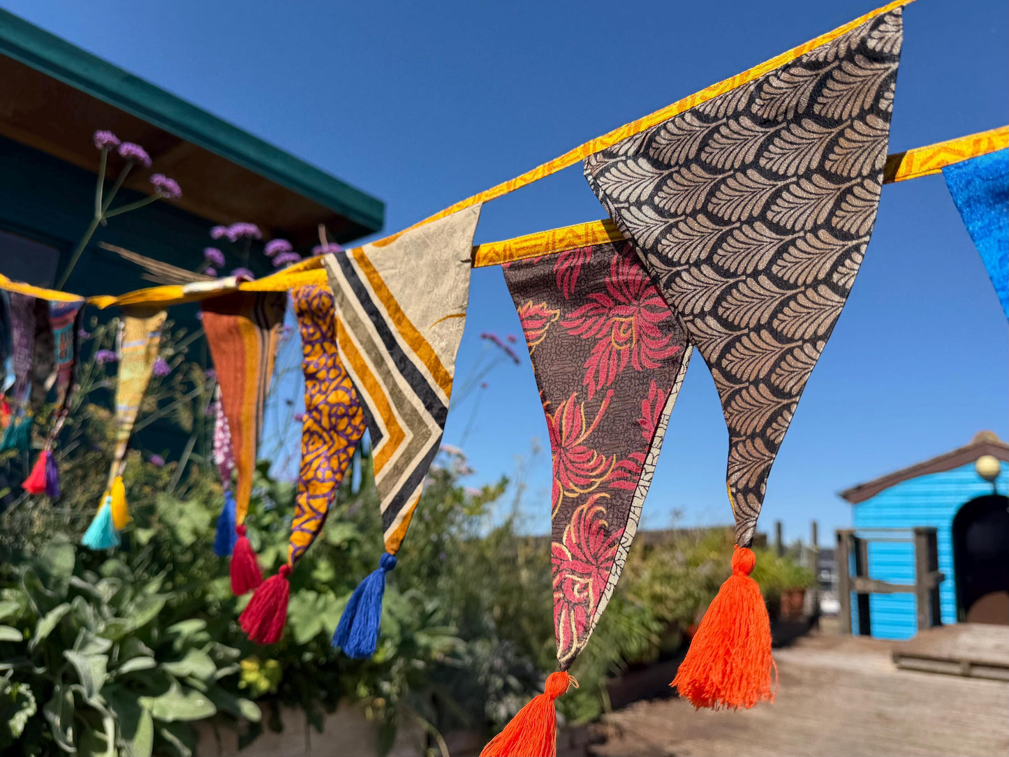 Recycled bunting with long ties and tassels. Boho bunting for home, garden and parties. Party flags with tassels.  Colourful  & eco friendly