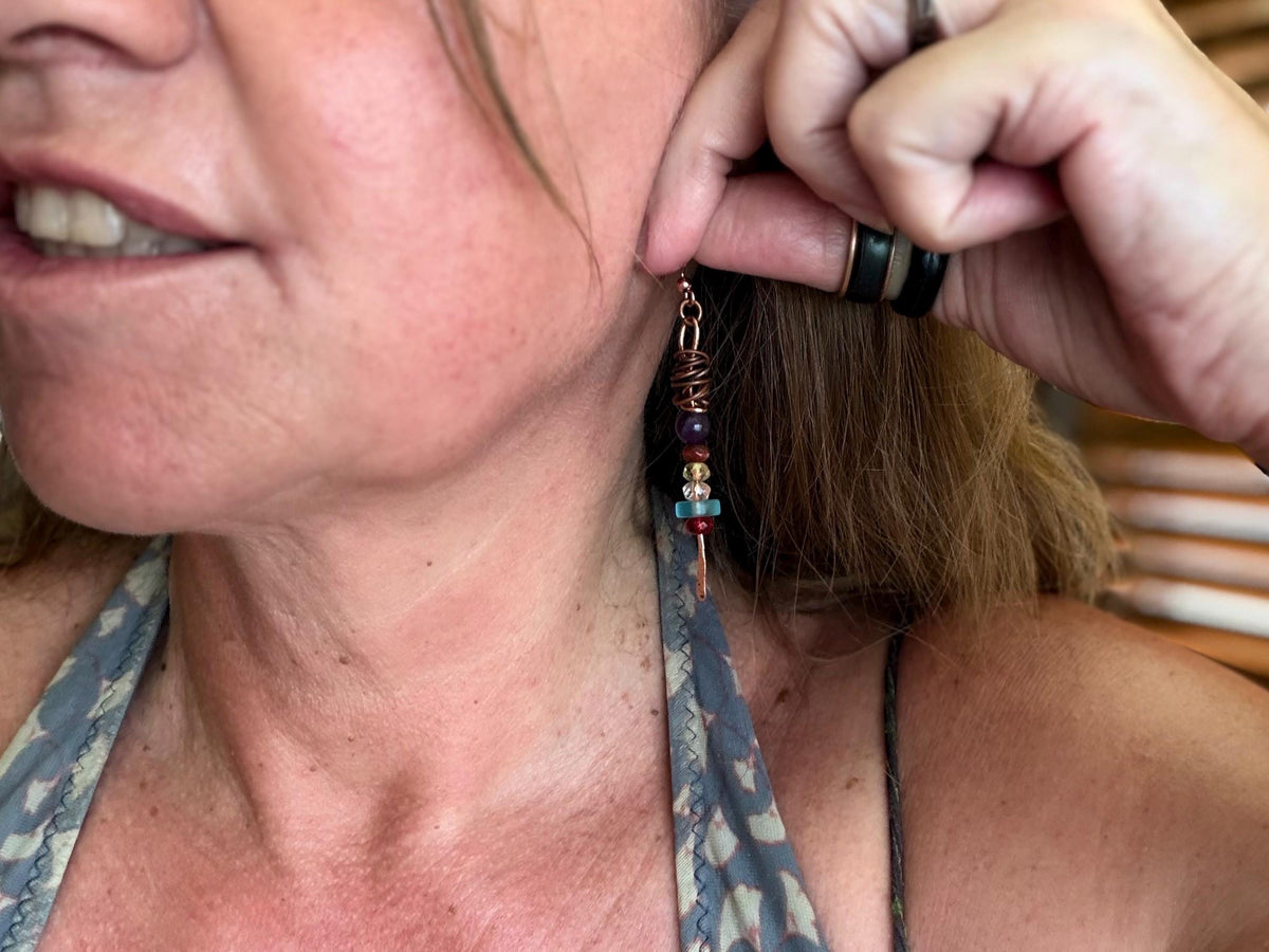 Eco friendly earrings made using recycled copper, sea glass & ethically sourced amethyst. Handmade ethical and unique jewellery.  Unusual.